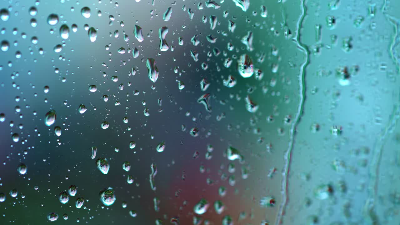 Fresh transparent drops on glass. Natural background with raindrops on the window. Rainy wet window. Close-up.