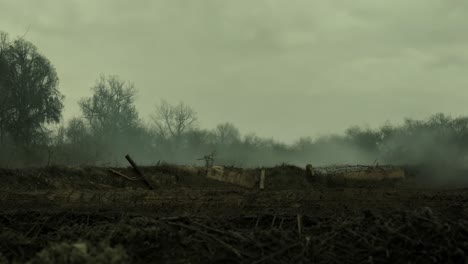 a deserted battlefield with smoke and fog