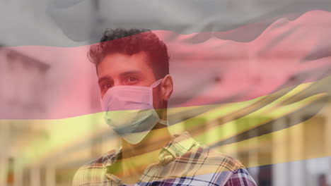 animation of flag of germany waving over latin man wearing face mask in city street