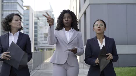 businesswomen with papers and digital tablet