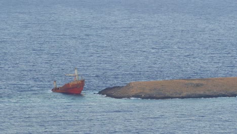 Still-shot-of-a-cargo-ship-wreck-accident-in-shallow-ocean-water