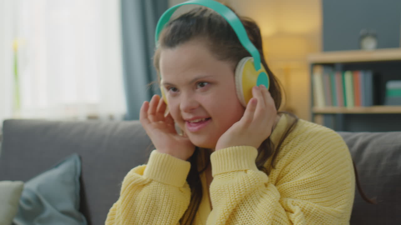 Girl with Down Syndrome Enjoying Music with Wireless Headphones
