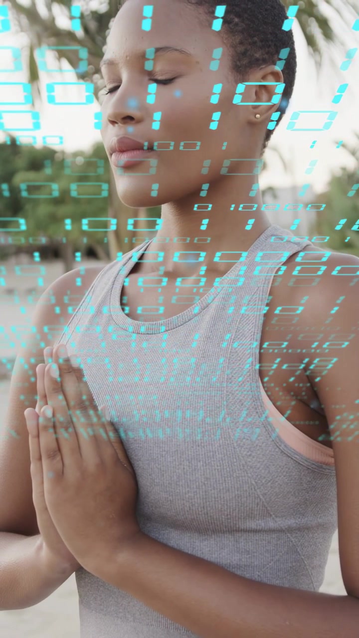Woman holding prayer pose on beach, cyan digits appearing on frame guiding meditation for health