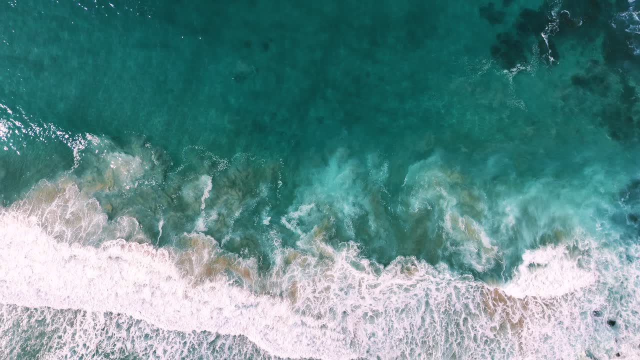 Slow motion turquoise water and waves seaside coast shore at sandy beach at Big Sur, California