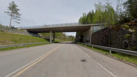 the combination of the road, the presence of cars, and the surrounding trees contributes to the distinct character and atmosphere of the village