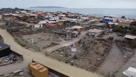 low flyover of rustic charming fishing village, caleta chanaral, chile