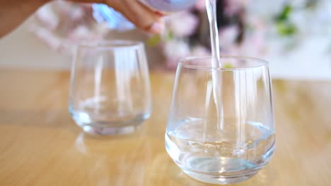 pouring water into glasses