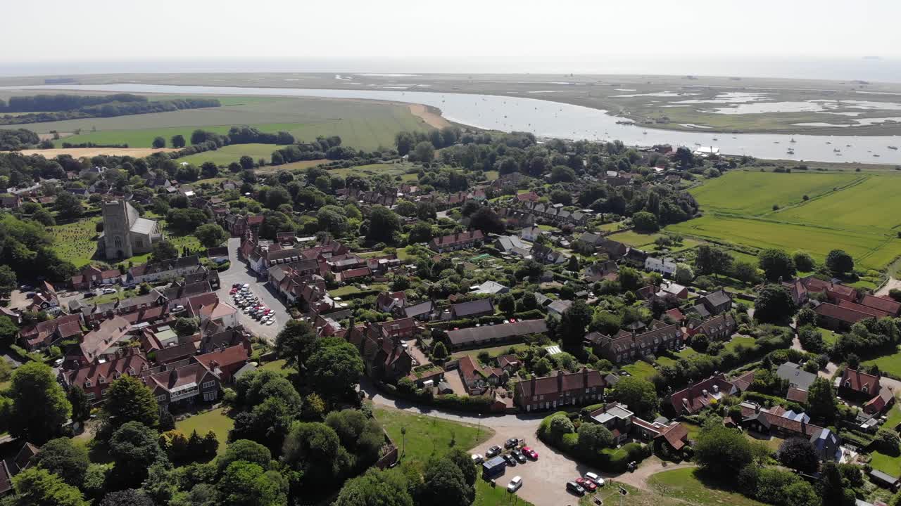 Revealing drone shot showing the village of Orford in Suffolk, UK. Orford is famous for its historical attractions, picturesque river quay and good restaurants and cafes. Orford, Suffolk, 21.06.25