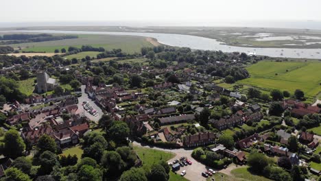revealing drone shot showing the village of orford in suffolk, uk. orford is famous for its historical attractions, picturesque river quay and good restaurants and cafes. orford, suffolk, 21.06.25