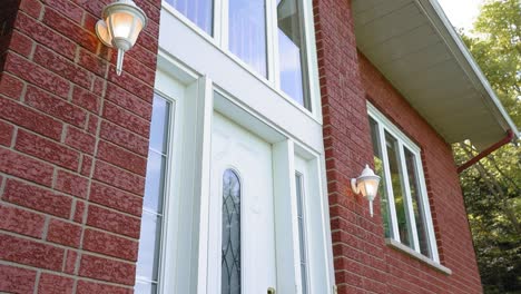 Beautiful-reveal-of-the-front-door-of-a-beautiful-red-brick-house-in-Quebec,-Canada