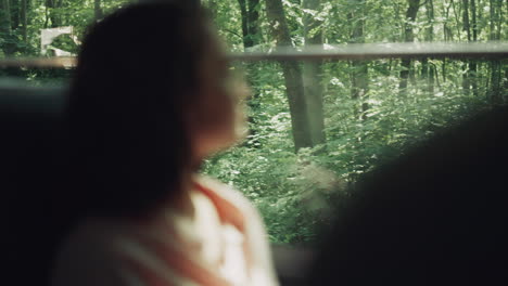 girl teenager riding in school bus alone. dreamy student looking in window.