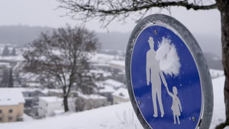 Close-up-slow-motion-of-a-snowball-hitting-a-pedestrian-sign