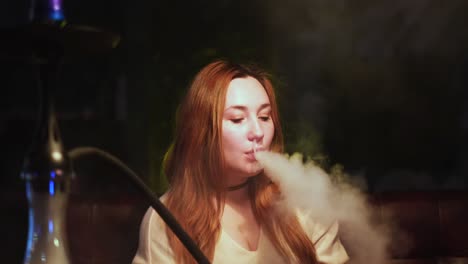 woman smoking hookah at night