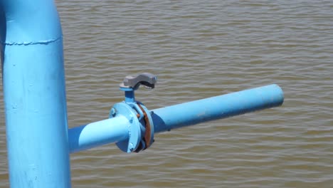 close up shot of a large tap of a center pivot irrigation sprinkler system along riverside in punjab at daytime