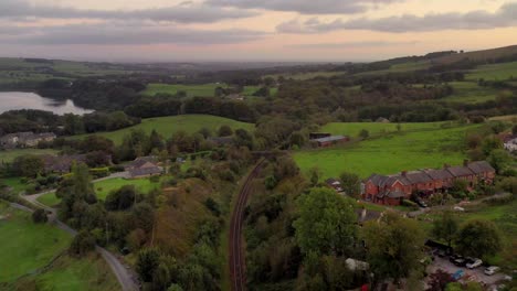 a railway track in the english countryside at sunset