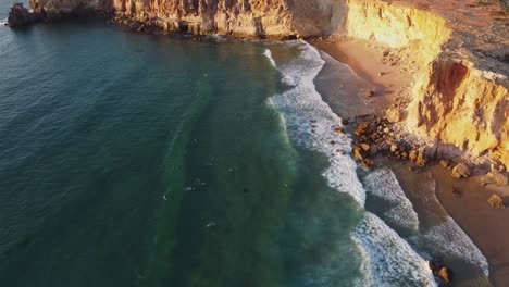 surfing at sunset on a beach in sagres in portugal