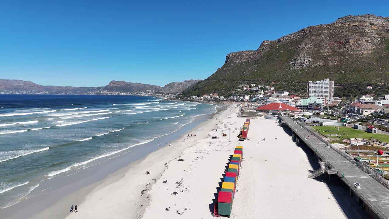 drone fly above white sand tropical beach with colourful cabin hut in Cape Town south Africa during a sunny day of summer
