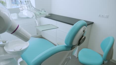 modern dental practice. dental chair and other accessories used by dentists in blue, medic light.