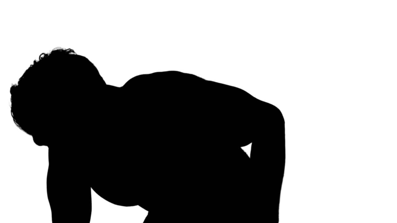 Muscular silhouette of man lifting dumbbels
