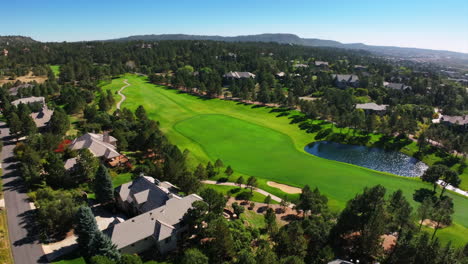 castle pines village north ridge golf course spring summer aerial drone denver colorado front range sunrise morning i25 highlands ranch park meadows daniels park homes green grass forward pan up