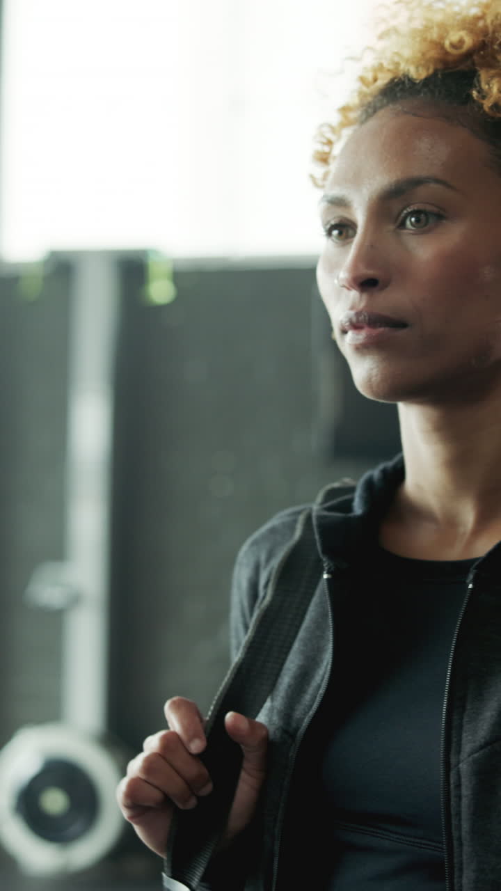 Focused Woman in Athletic Wear Standing in a Gym