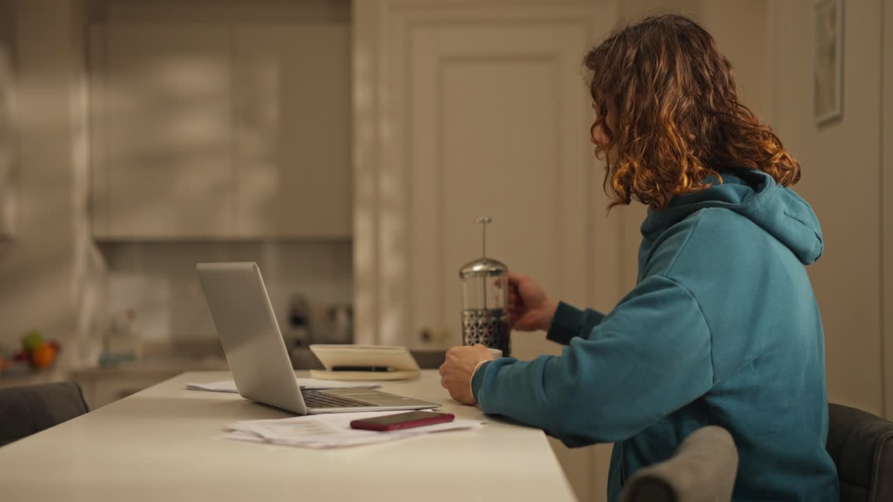 Man working on laptop in the kitchen