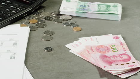 Chinese Yuan and Financial Documents on a Desk
