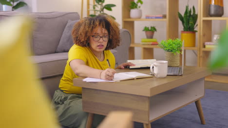 laptop, notebook and woman writing in the living