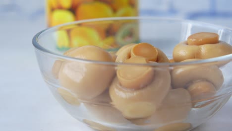 canned mushrooms in glass bowl