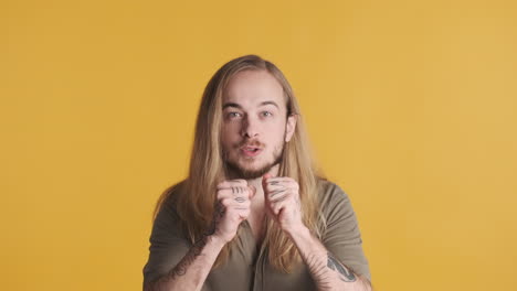 caucasian young man celebrating in front of the camera.