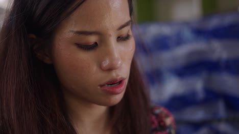 close-up portrait of a young woman looking down