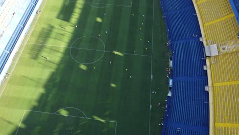 aerial birds eye shot of professional soccer player during session in bombonera stadium of boca juniors