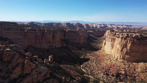 Slow-flydown-into-canyon-with-sunset-illuminating-the-cliff-walls