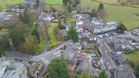 Approaching-drone-shot-of-the-center-of-Grasmere,-a-village-located-at-the-Lake-District,-located-in-Cumbria-at-Westmorland-and-Furness,-Northwest-England-in-United-Kingdom