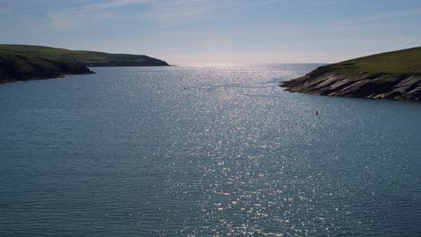 timelapse footage of a sparkling blue ocean, cloudless sky and rugged coast