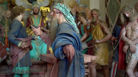 terracotta sculptures of jesus christ on the road to calvary on a biblical character scene representation from a chapel of famous sacred mountain of varallo, an unesco world heritage site