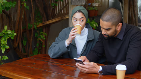 Couple-sitting-in-cafeteria-4k