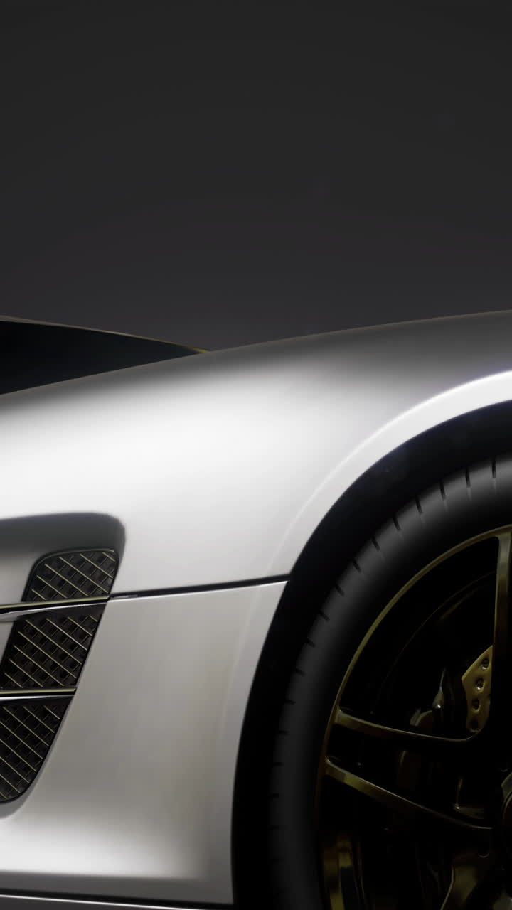 Sleek silver sports car elegantly displayed under dramatic lighting