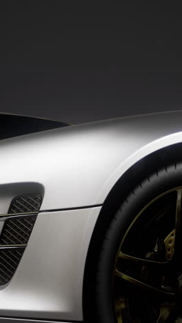 sleek silver sports car elegantly displayed under dramatic lighting