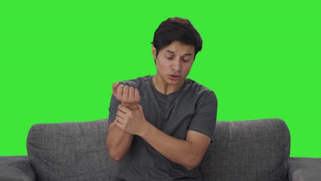 sick indian man suffering from wrist pain green screen