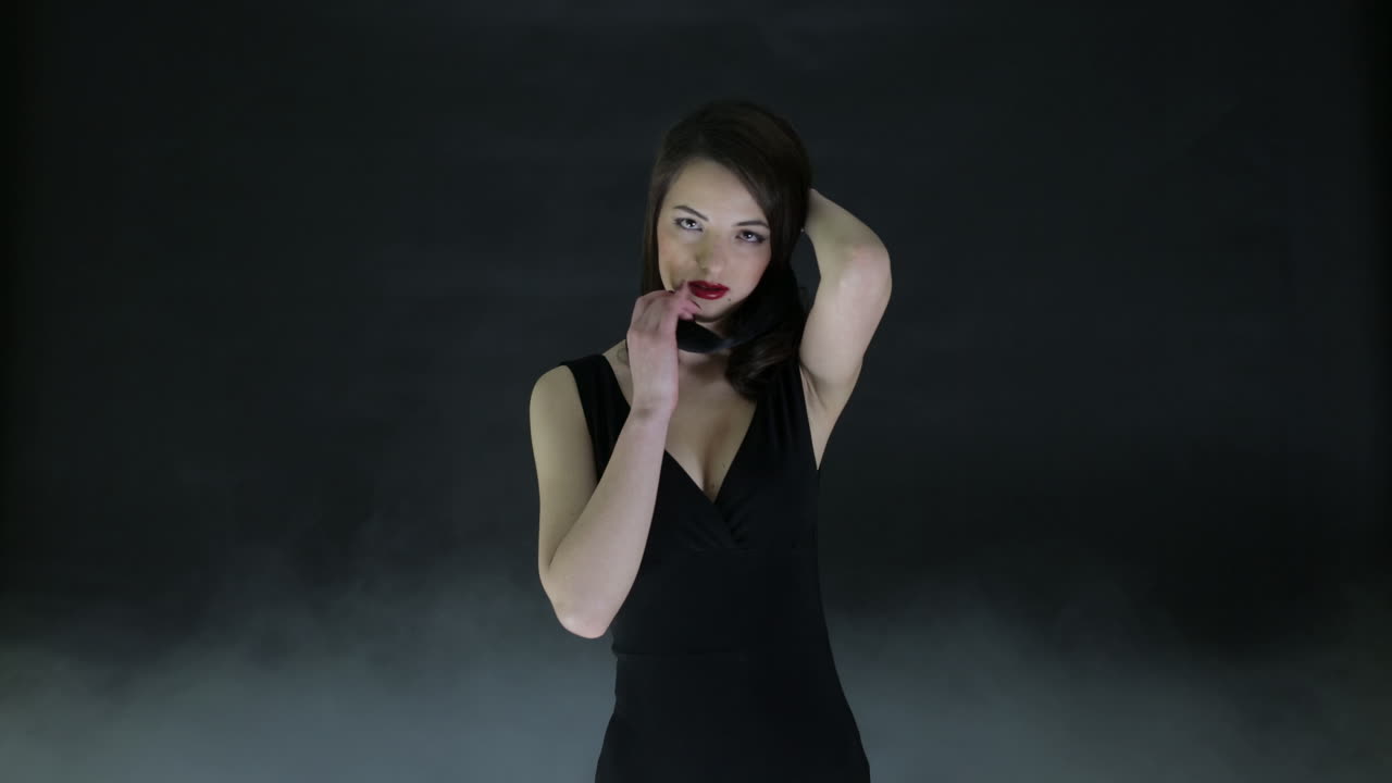 mujer con vestido negro con los ojos cubiertos