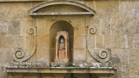 Static-closeup-of-praying-saint-mary-in-recessed-window-above-chapel-door