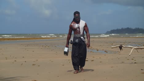 a muscular, dark-skinned man, flawlessly portraying nekharis in cosplay, stands on a tropical beach