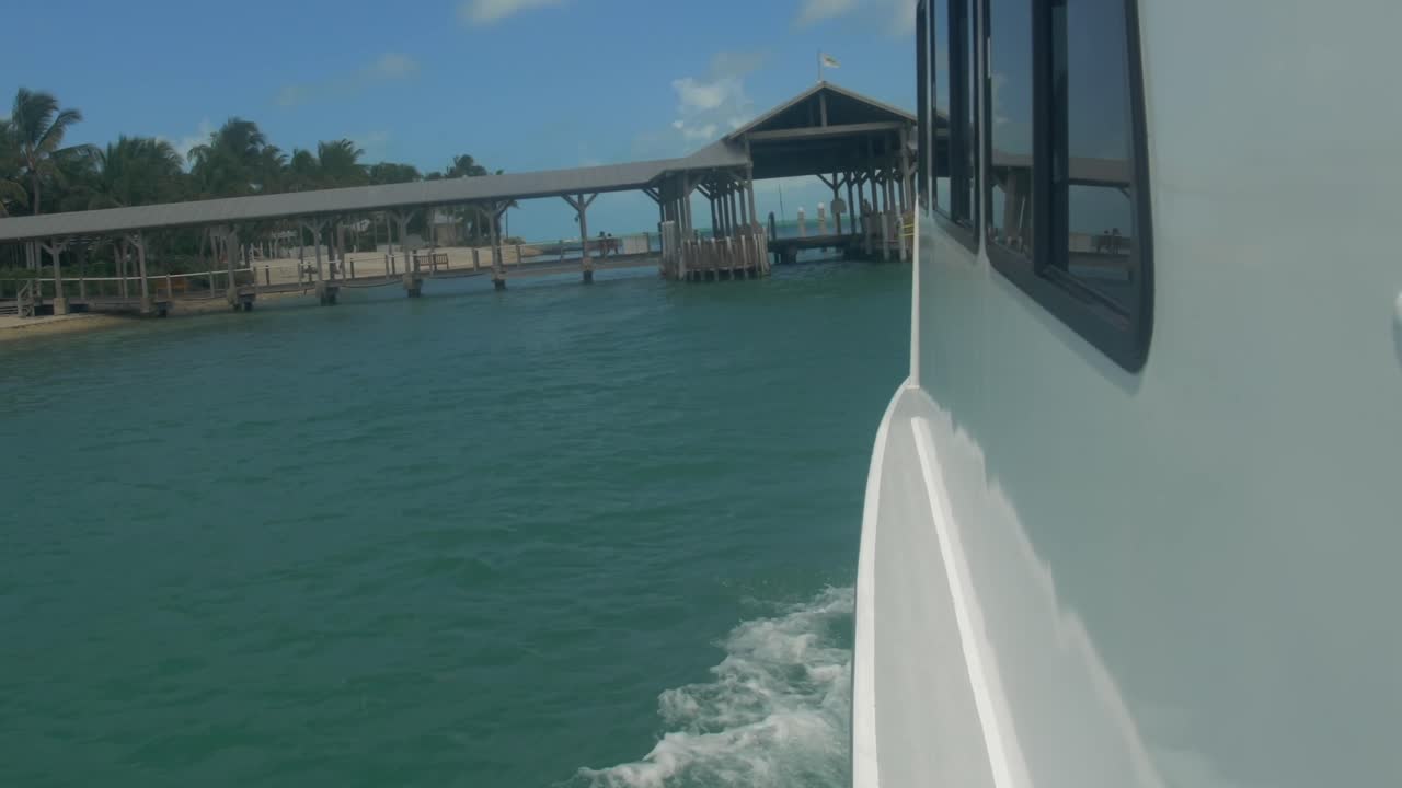 Coastline in Key West Florida with roped off swimming area near ferry dock