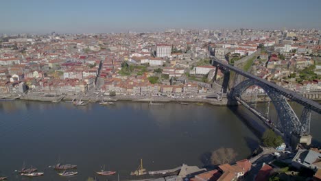 Aerial-descent-over-the-rooftops-of-Gaia-with-a-stunning-panorama-of-the-Porto-Old-Town-and-famous-Ponte-Dom-Luís-I