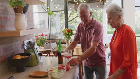 senior caucasian couple cooking together in the kitchen