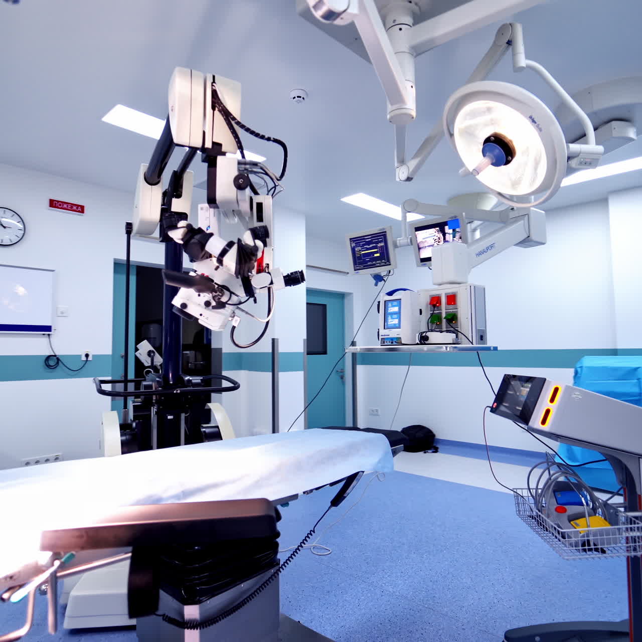 Medical equipment in an empty surgical room. Establishing shot of technologically advanced operating room with no people.