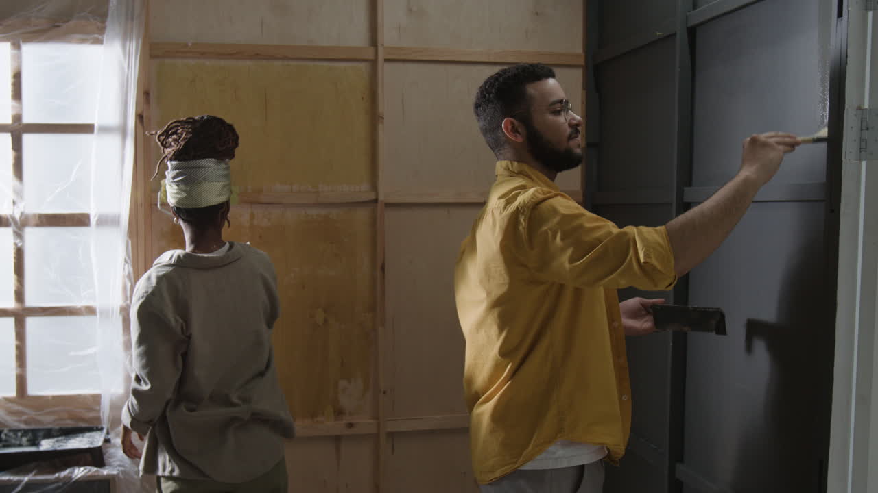 People painting a wall