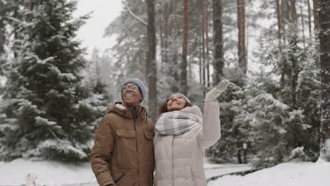 couple enjoying a snowy day in the forest