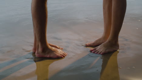 couples feet at the beach